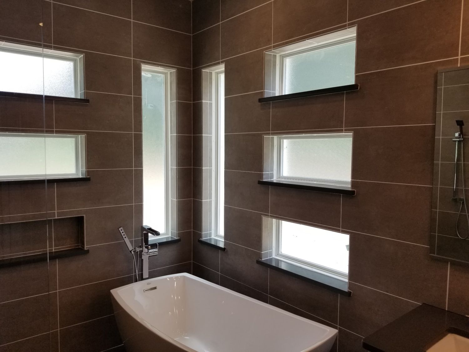 Dark tile bathroom soaking tub by Stephen Wade Gibson Flooring, Central Florida