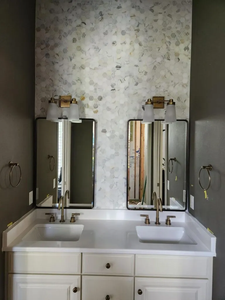 Double vanity with a mosaic tile feature wall