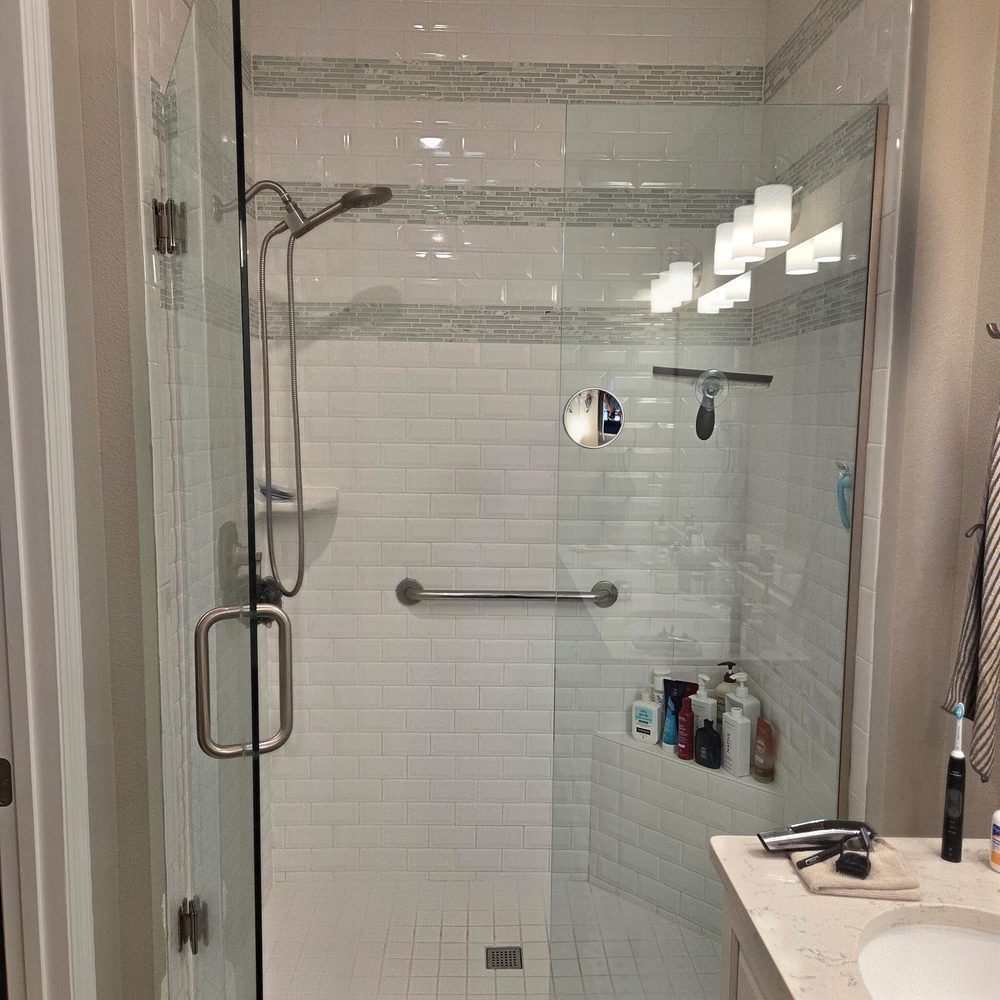 Glass shower enclosure with tiled walls