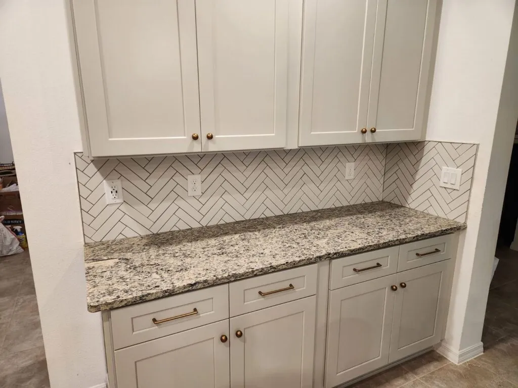 Herringbone marble kitchen backsplash