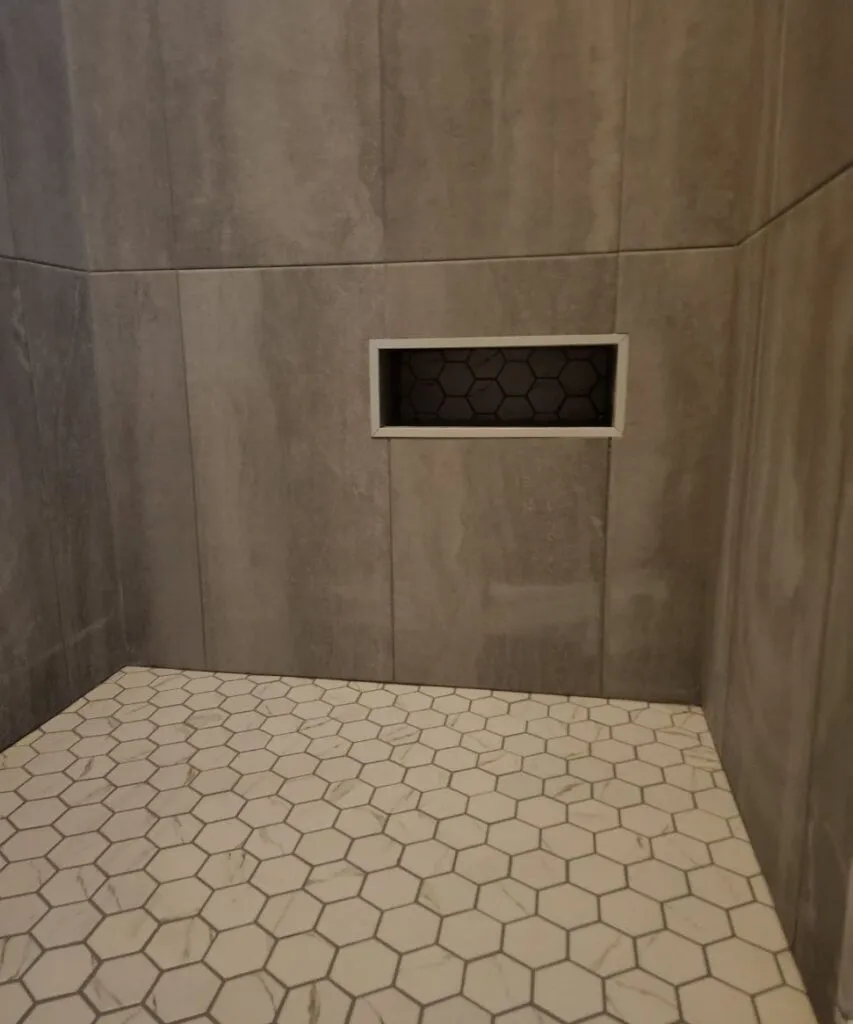 Hex tile shower floor sloped to the drain
