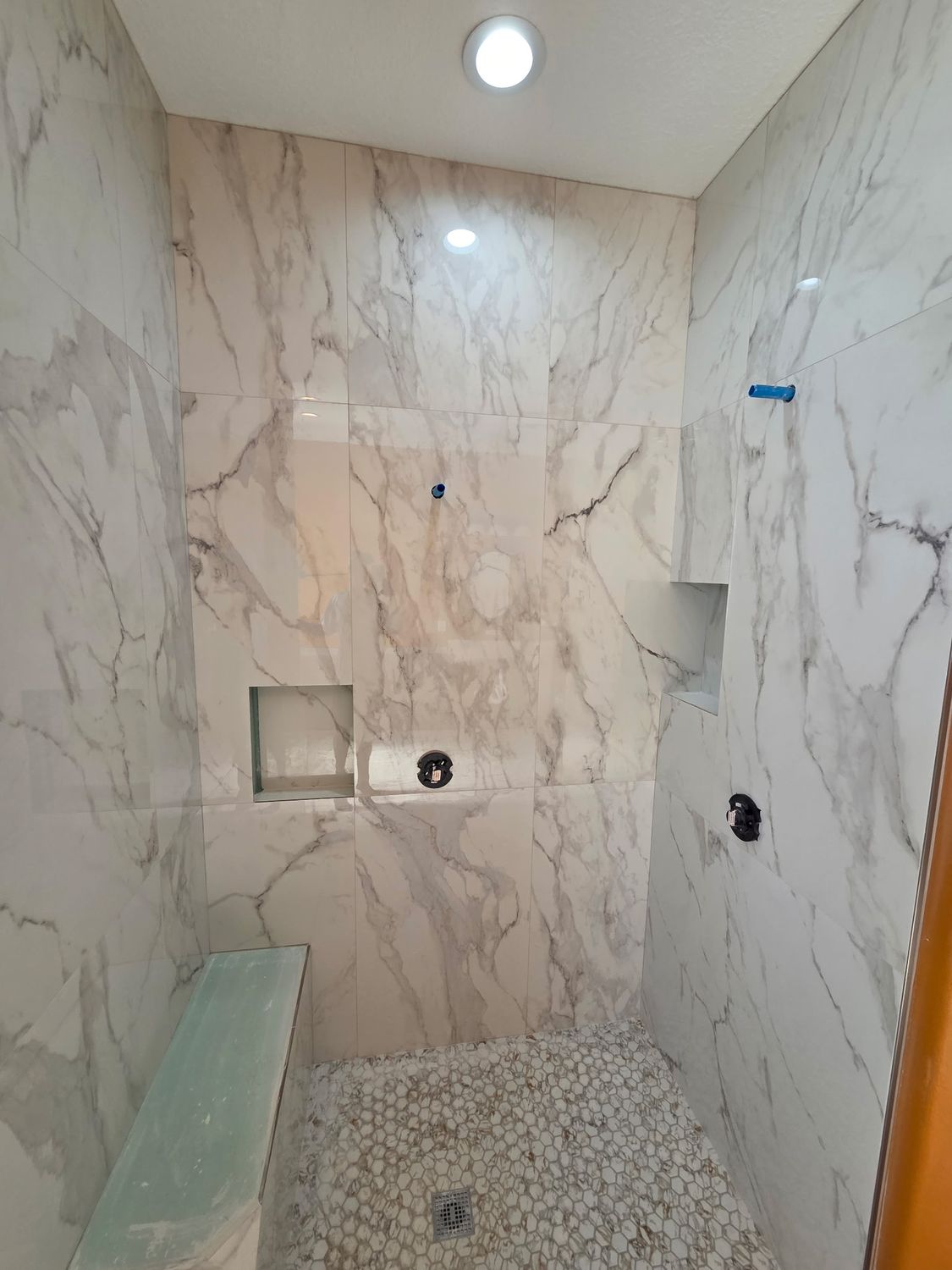 Marble shower pebble floor by Stephen Wade Gibson Flooring, Central Florida