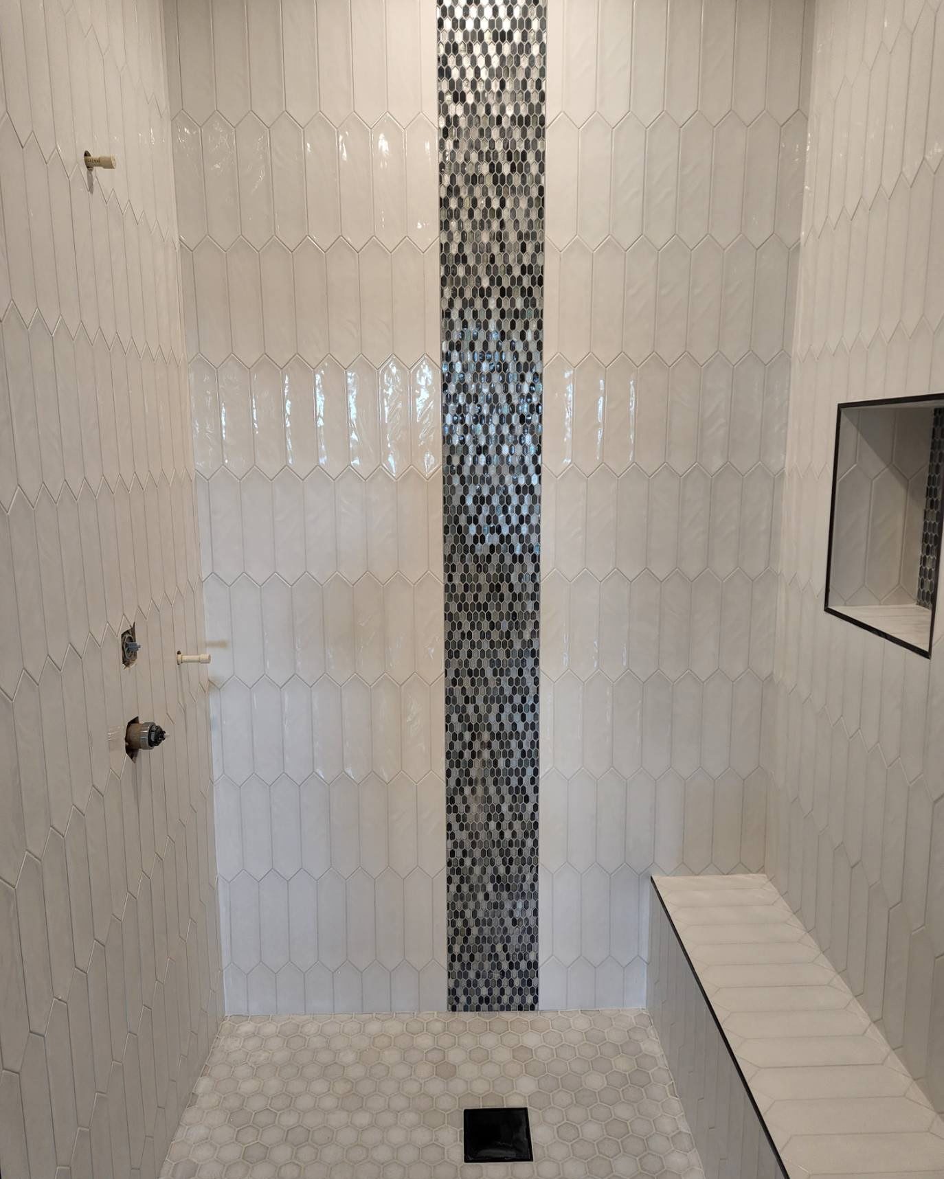 Picket tile shower with a mosaic accent strip