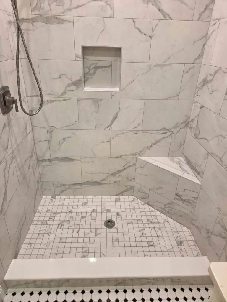 Shower with a marble mosaic pan